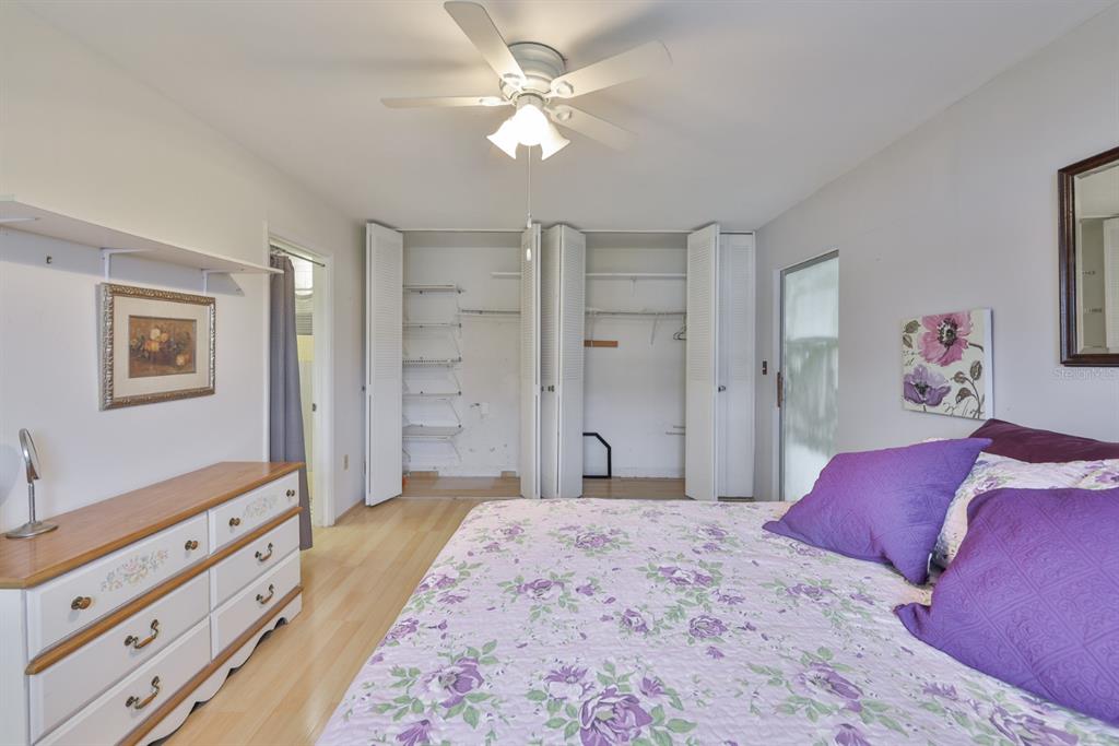 1901 Andover Way, Unit 38 Sun City Center, FL 33573 - Photo 19 of 54 a bedroom with a large bed and a chandelier