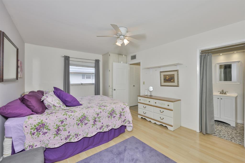 1901 Andover Way, Unit 38 Sun City Center, FL 33573 - Photo 20 of 54 a bedroom with a bed and a chandelier