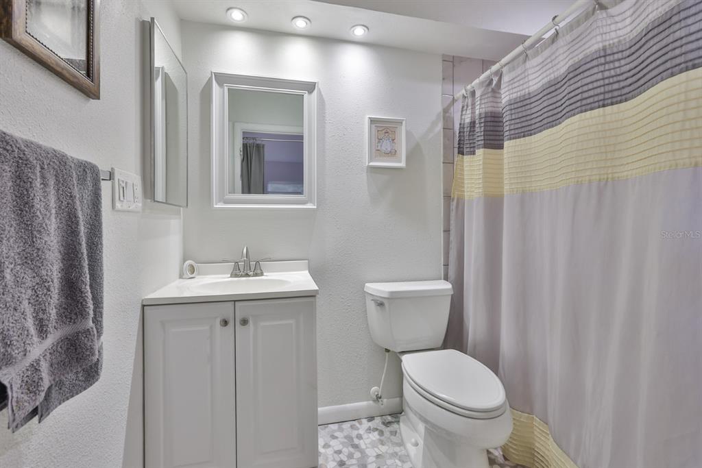 1901 Andover Way, Unit 38 Sun City Center, FL 33573 - Photo 21 of 54 a bathroom with a toilet a sink and mirror