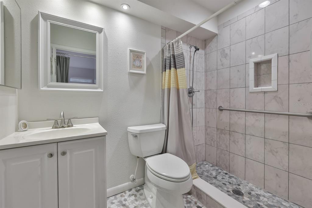 1901 Andover Way, Unit 38 Sun City Center, FL 33573 - Photo 22 of 54 a bathroom with a sink toilet and shower