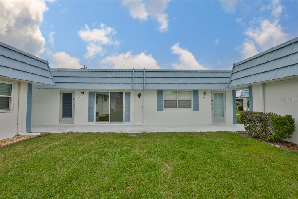 1901 Andover Way, Unit 38 Sun City Center, FL 33573 - Photo 27 of 54 a front view of a house with a garden
