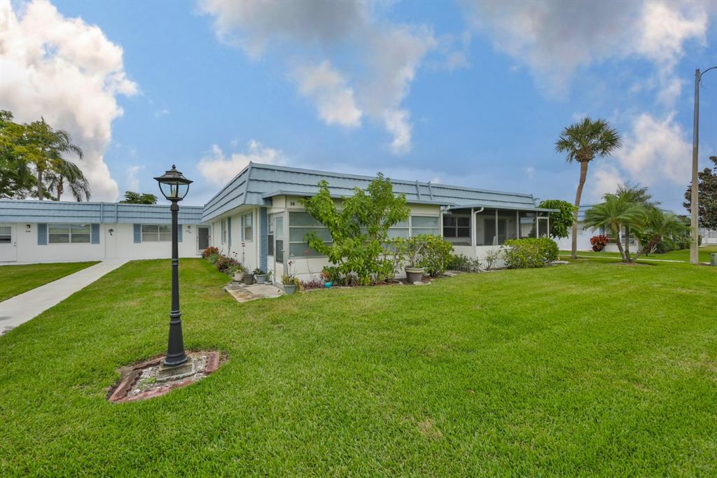 1901 Andover Way, Unit 38 Sun City Center, FL 33573 - Photo 3 of 54 a front view of a house with a yard