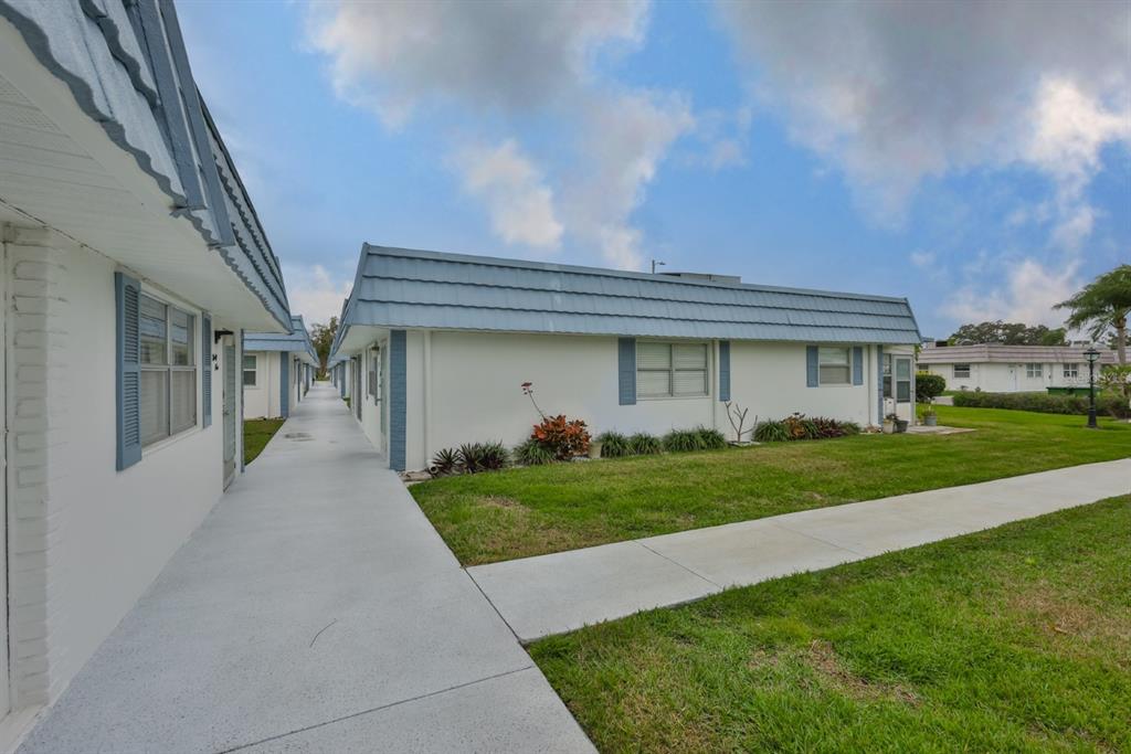 1901 Andover Way, Unit 38 Sun City Center, FL 33573 - Photo 4 of 54 a front view of a house with a yard and garage