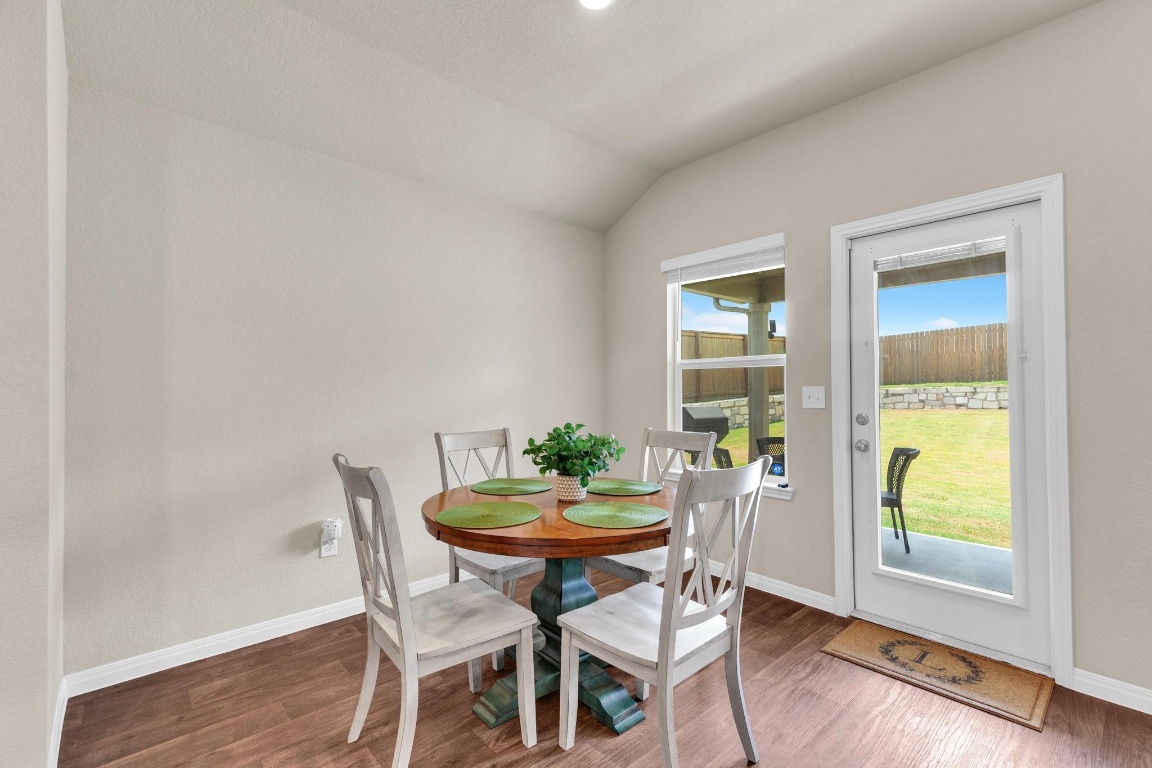 19525 Abigail Fillmore Road Manor, TX 78653 - Photo 14 of 40 Dining room featuring wood finished floors and lofted ceiling