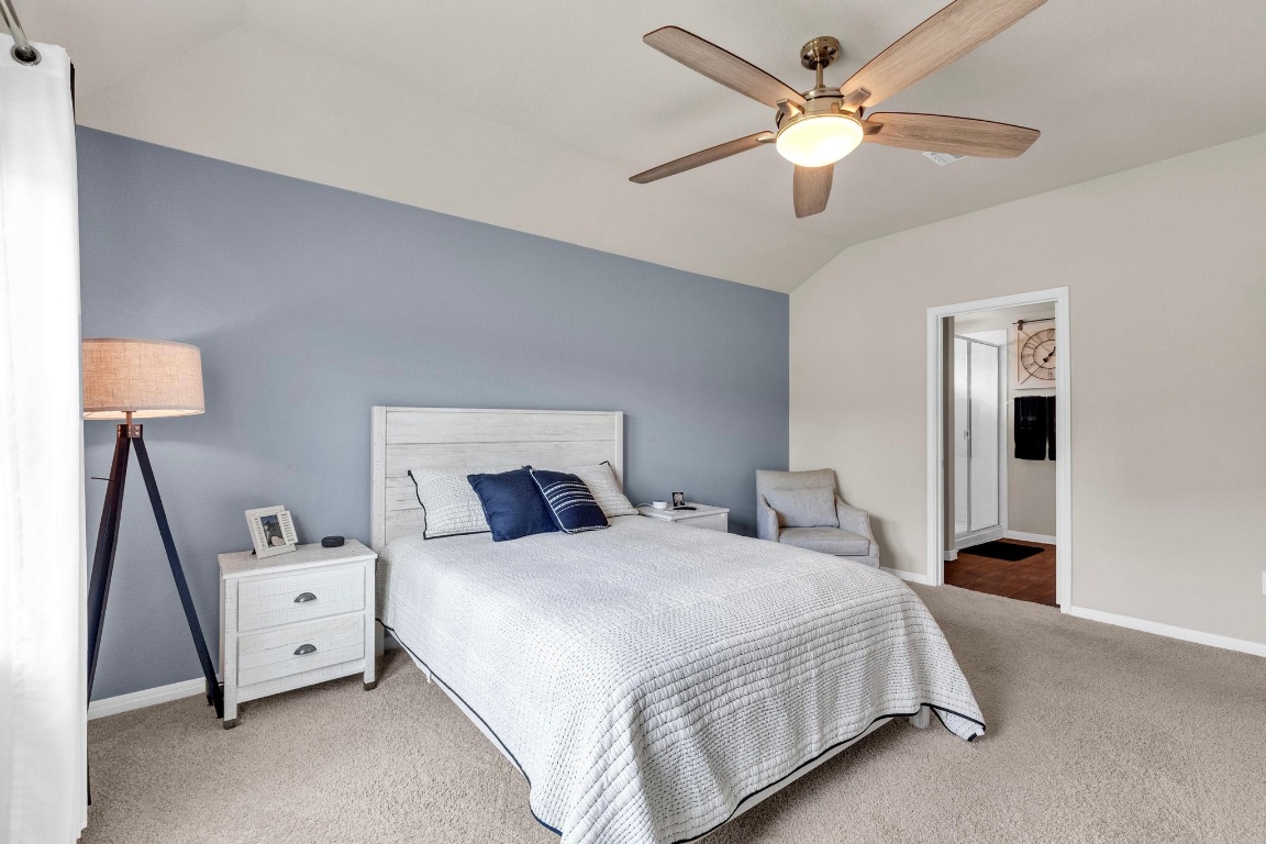 19525 Abigail Fillmore Road Manor, TX 78653 - Photo 20 of 40 Bedroom with carpet, lofted ceiling, and ceiling fan