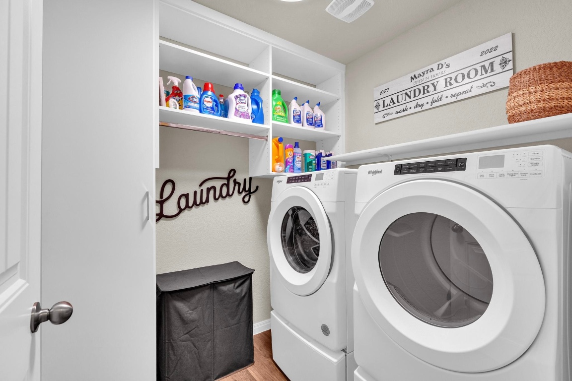 19525 Abigail Fillmore Road Manor, TX 78653 - Photo 24 of 40 Laundry room with separate washer and dryer and light wood-style flooring
