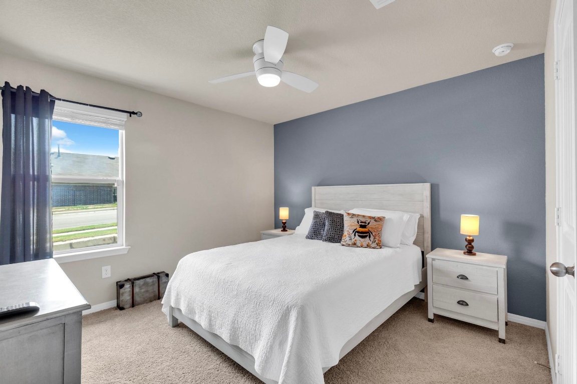 19525 Abigail Fillmore Road Manor, TX 78653 - Photo 26 of 40 Bedroom featuring light colored carpet and a ceiling fan