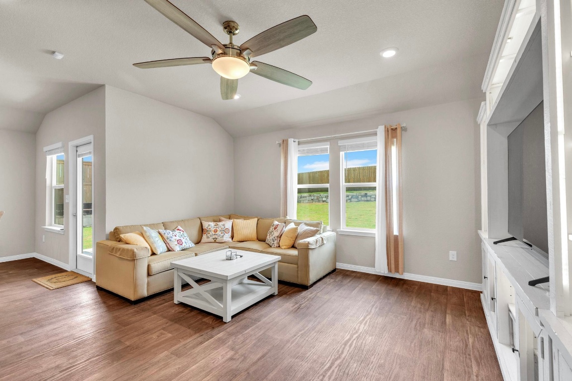 19525 Abigail Fillmore Road Manor, TX 78653 - Photo 10 of 40 Living room featuring lofted ceiling, light wood-type flooring, ceiling fan, and recessed lighting