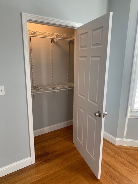 243 Bruce Street Lawrence, MA 01841 - Photo 16 of 16 a view of an empty room with wooden floor and a window