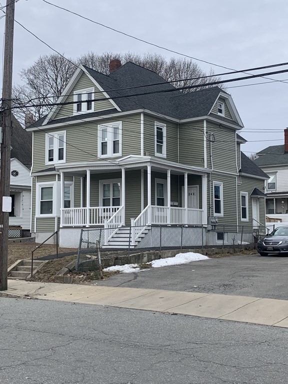 243 Bruce Street Lawrence, MA 01841 - Photo 2 of 16 a front view of a house with a yard