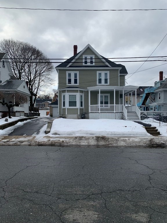 243 Bruce Street Lawrence, MA 01841 - Photo 4 of 16 a front view of a house with a yard