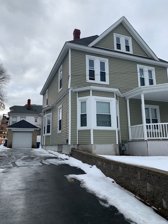 243 Bruce Street Lawrence, MA 01841 - Photo 5 of 16 a front view of a house with a yard