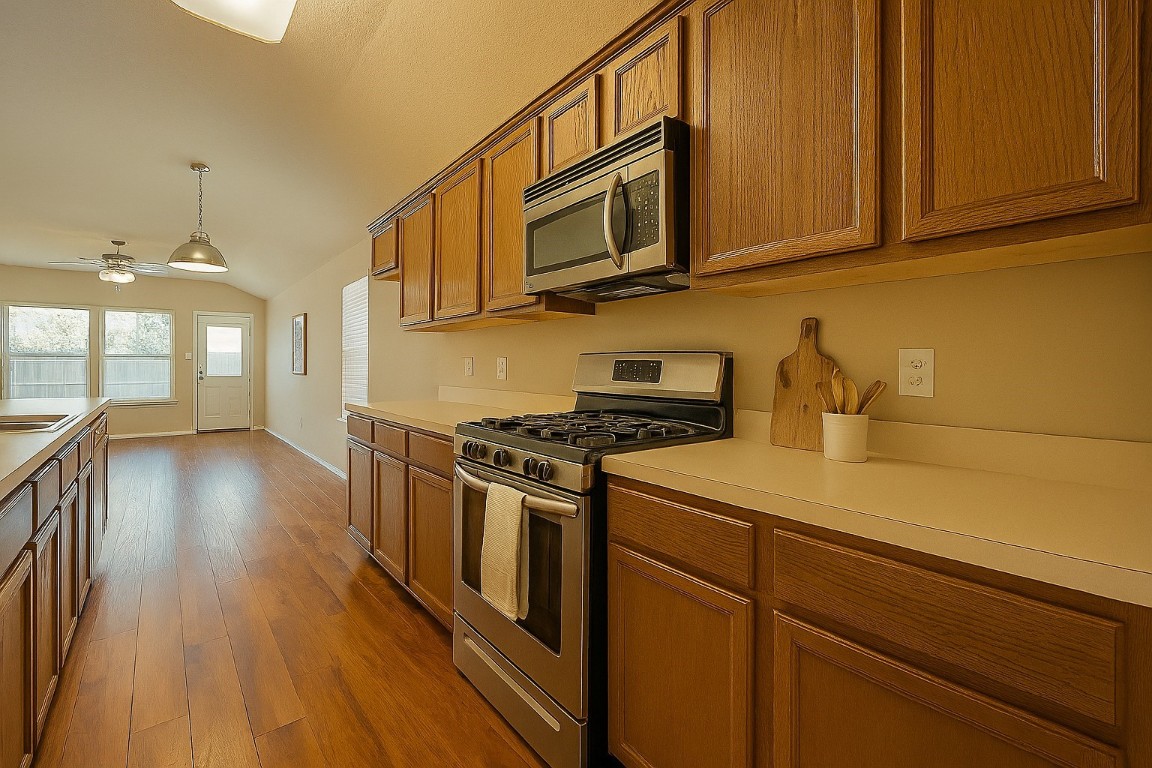 3611 Apache Meadows Drive Baytown, TX 77521 - Photo 8 of 12 a kitchen with stainless steel appliances granite countertop a stove a sink and a microwave