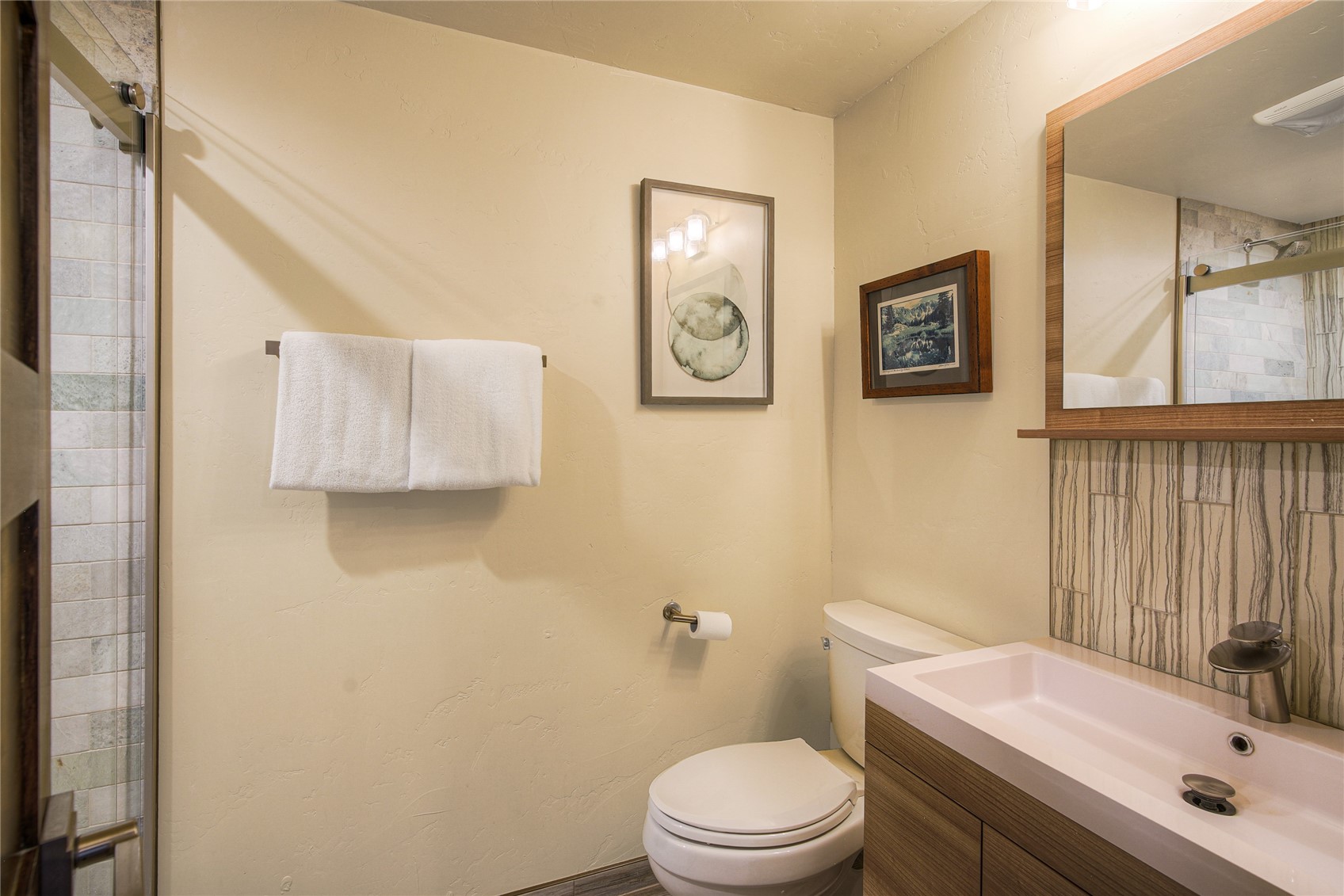187 Fuller Placer Road, Unit F Breckenridge, CO 80424 - Photo 18 of 46 a bathroom with a sink a toilet and mirror