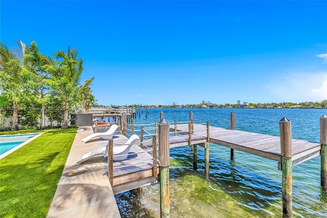 a view of a hallway with wooden floor and furniture