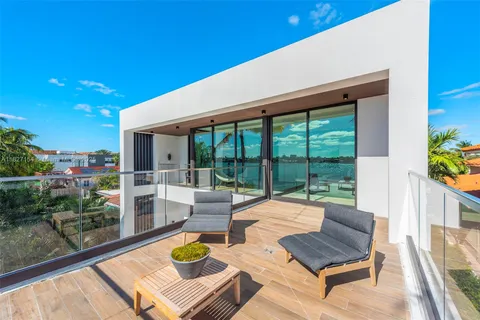 a bedroom with furniture and a large window