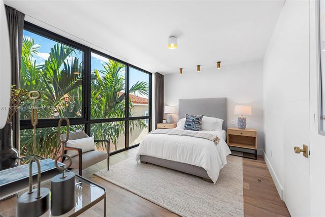 a view of a house with swimming pool and sitting area