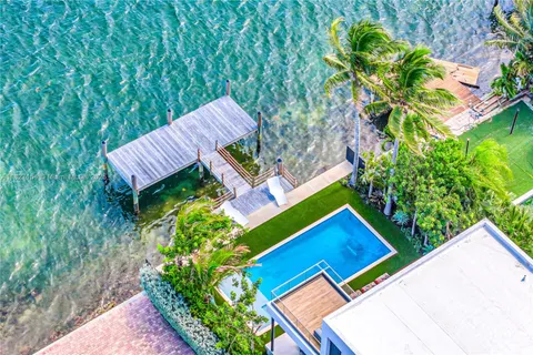 a living room with furniture kitchen view and a large window