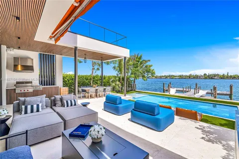 a kitchen with stainless steel appliances kitchen island a large window and cabinets