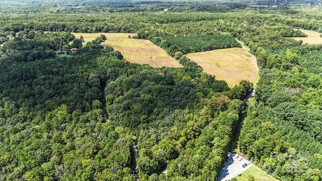 an aerial view of a house with a yard and lake view