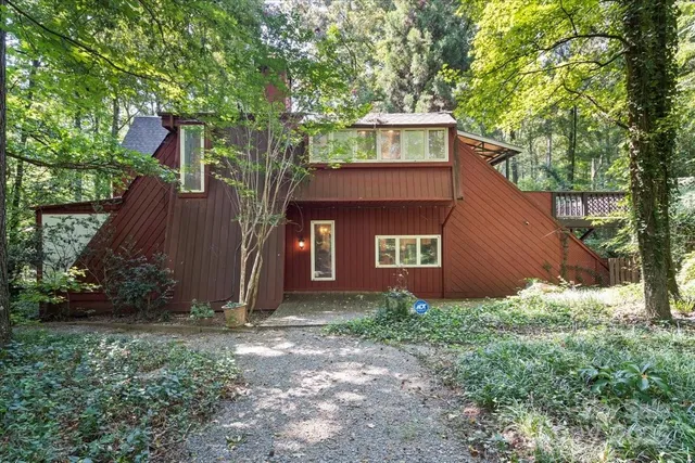 a house is sitting in middle of the yard