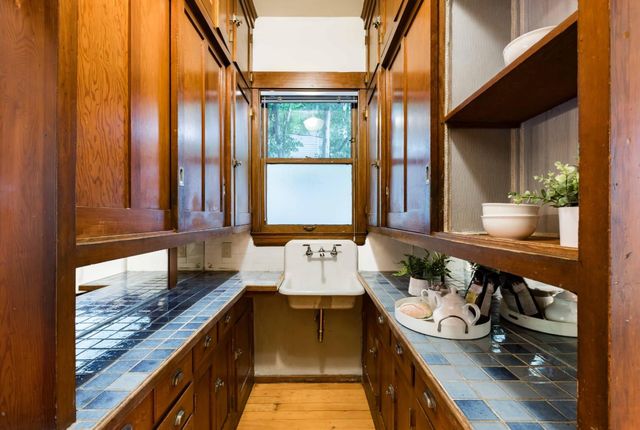 a bathroom with a granite countertop sink and a large mirror