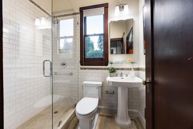 a bathroom with a toilet sink and mirror
