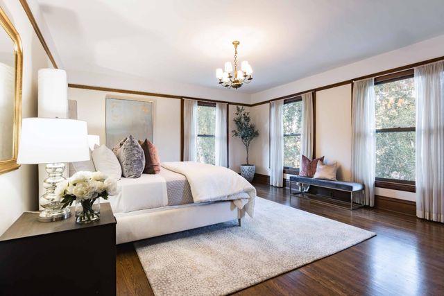 a spacious bedroom with a bed and a couch