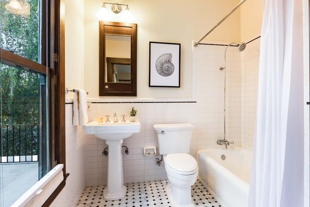 a bathroom with a toilet a sink and a window