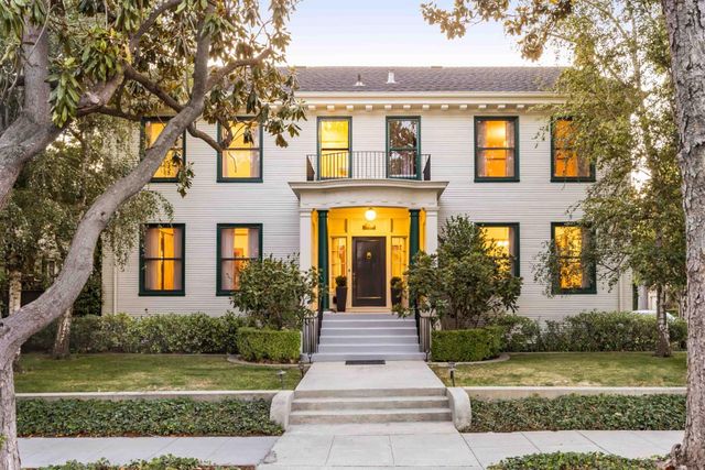 front view of a brick house with a yard
