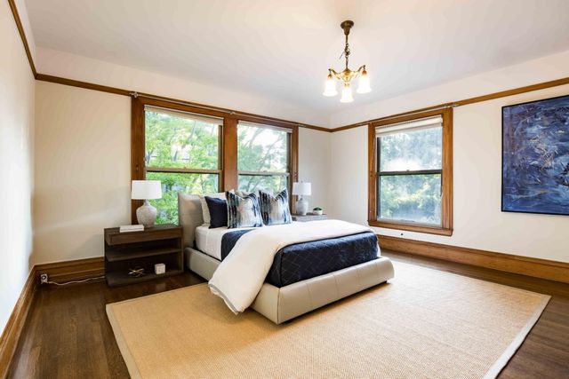 a spacious bedroom with a bed and a large window