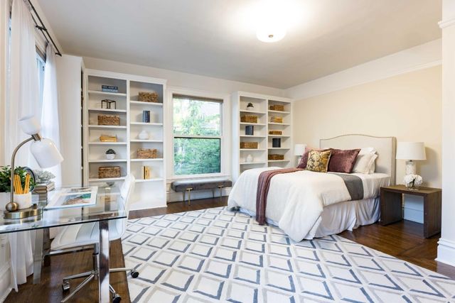 a bedroom with a bed and a table with window