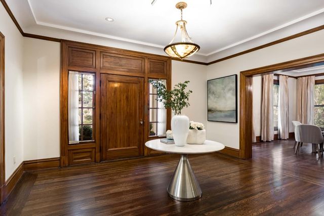 a view of a dining room with furniture wooden floor and chandelier