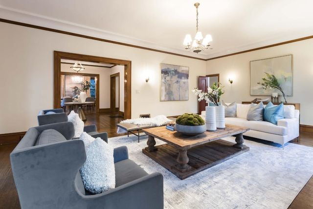 a living room with furniture and a chandelier
