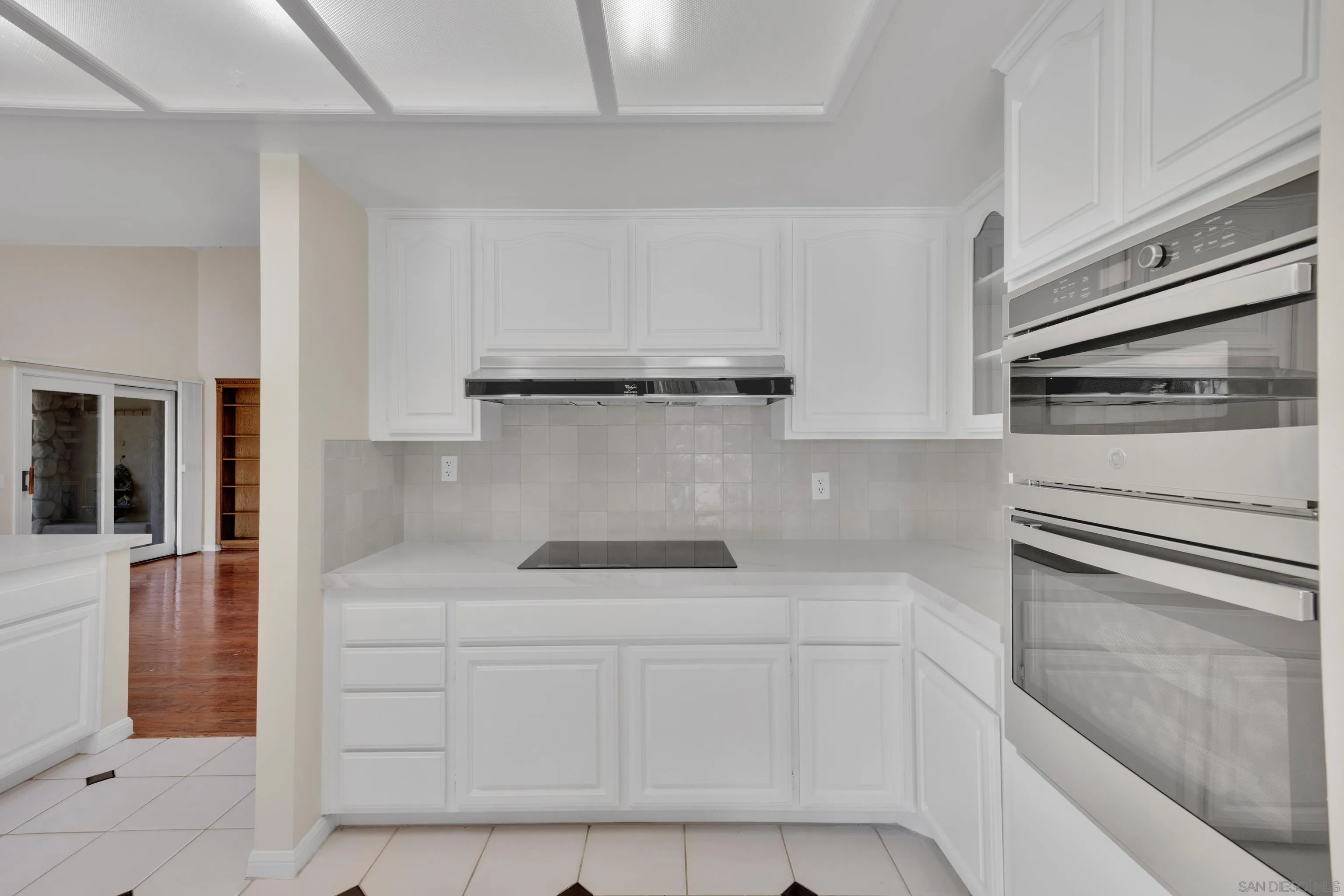 15235 Crestview Court Poway, CA 92064 - Photo 21 of 75 a kitchen with white cabinets and white appliances