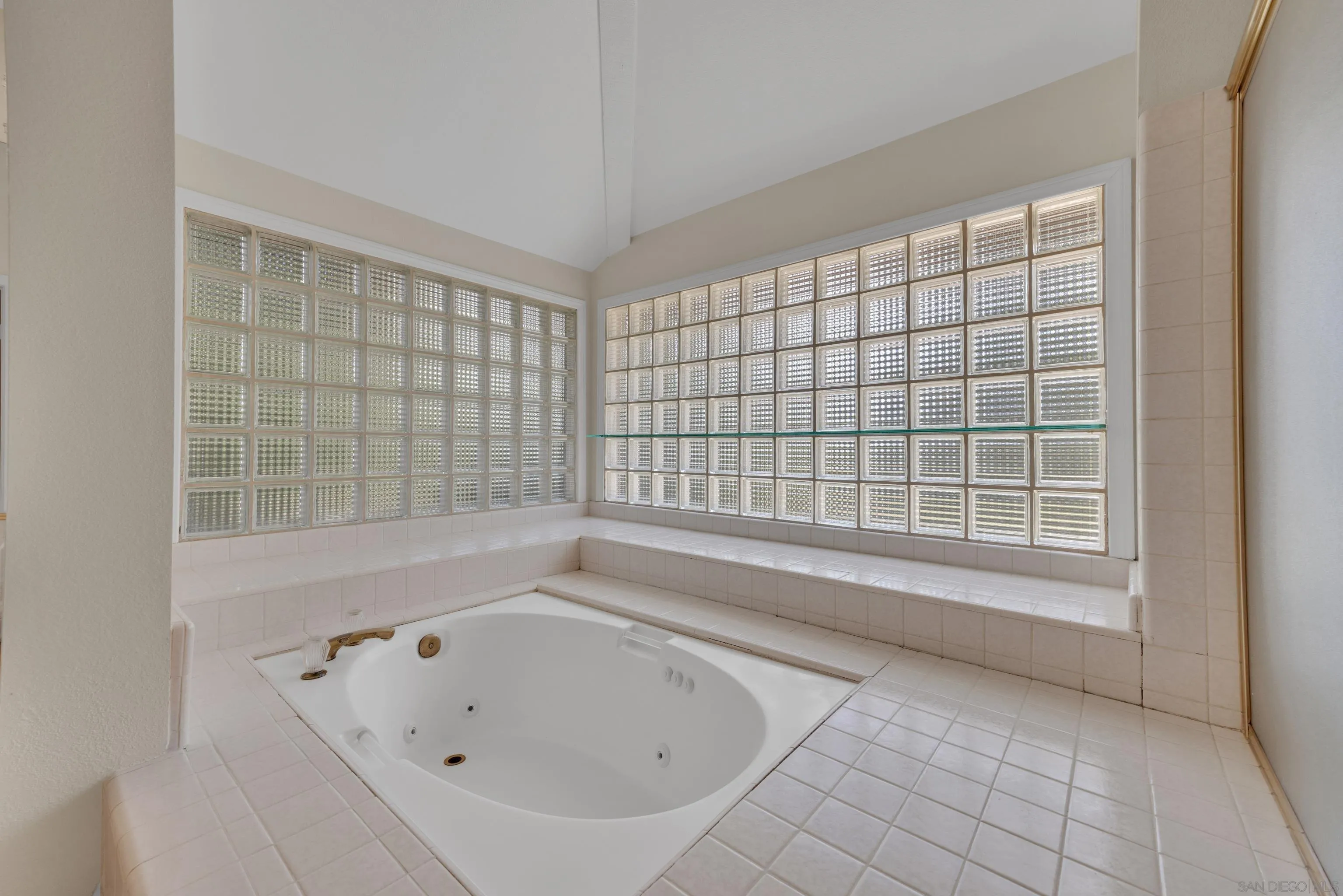 15235 Crestview Court Poway, CA 92064 - Photo 33 of 75 a bathroom with a bathtub and next to a window