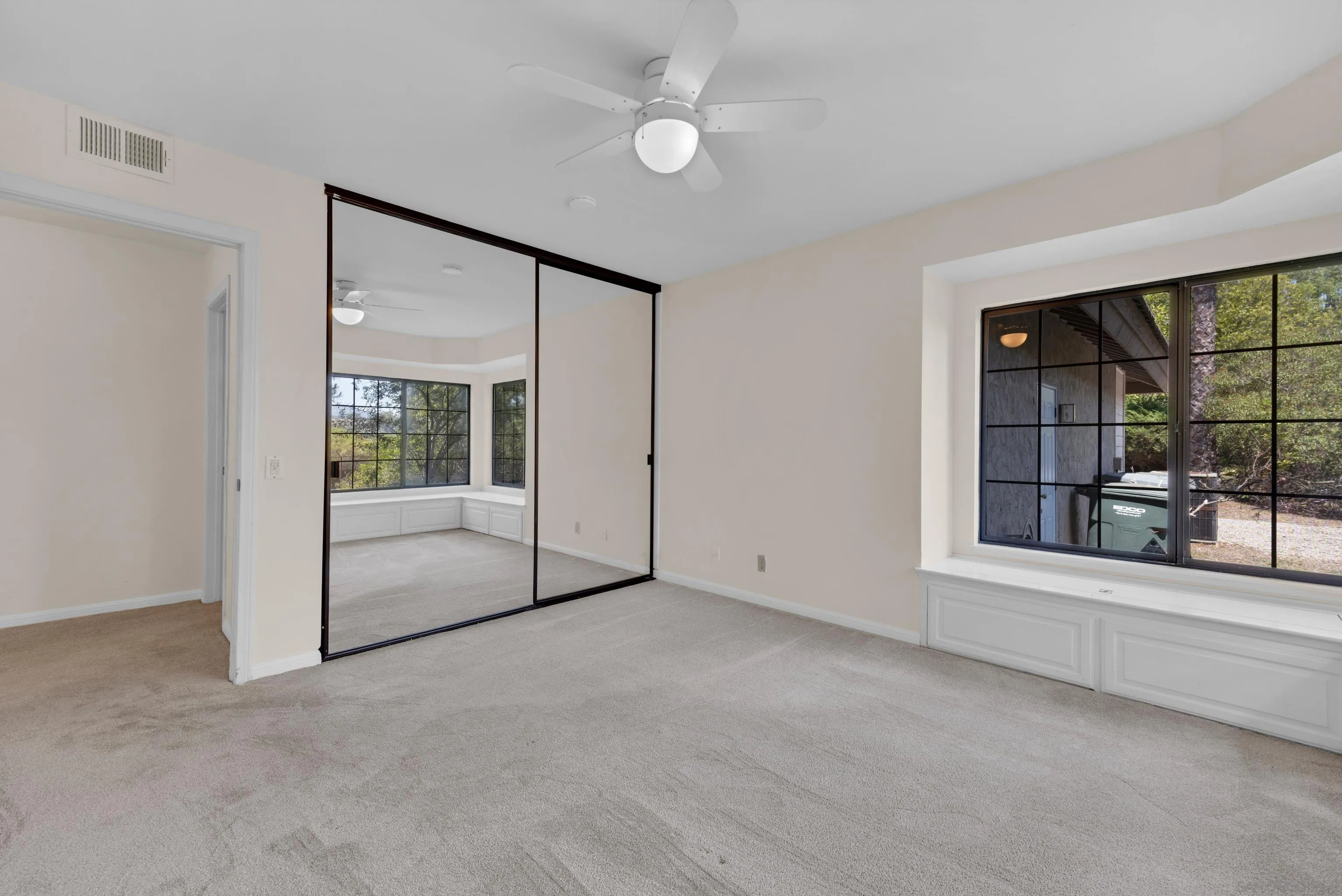 15235 Crestview Court Poway, CA 92064 - Photo 39 of 75 an empty room with sliding glass door and windows