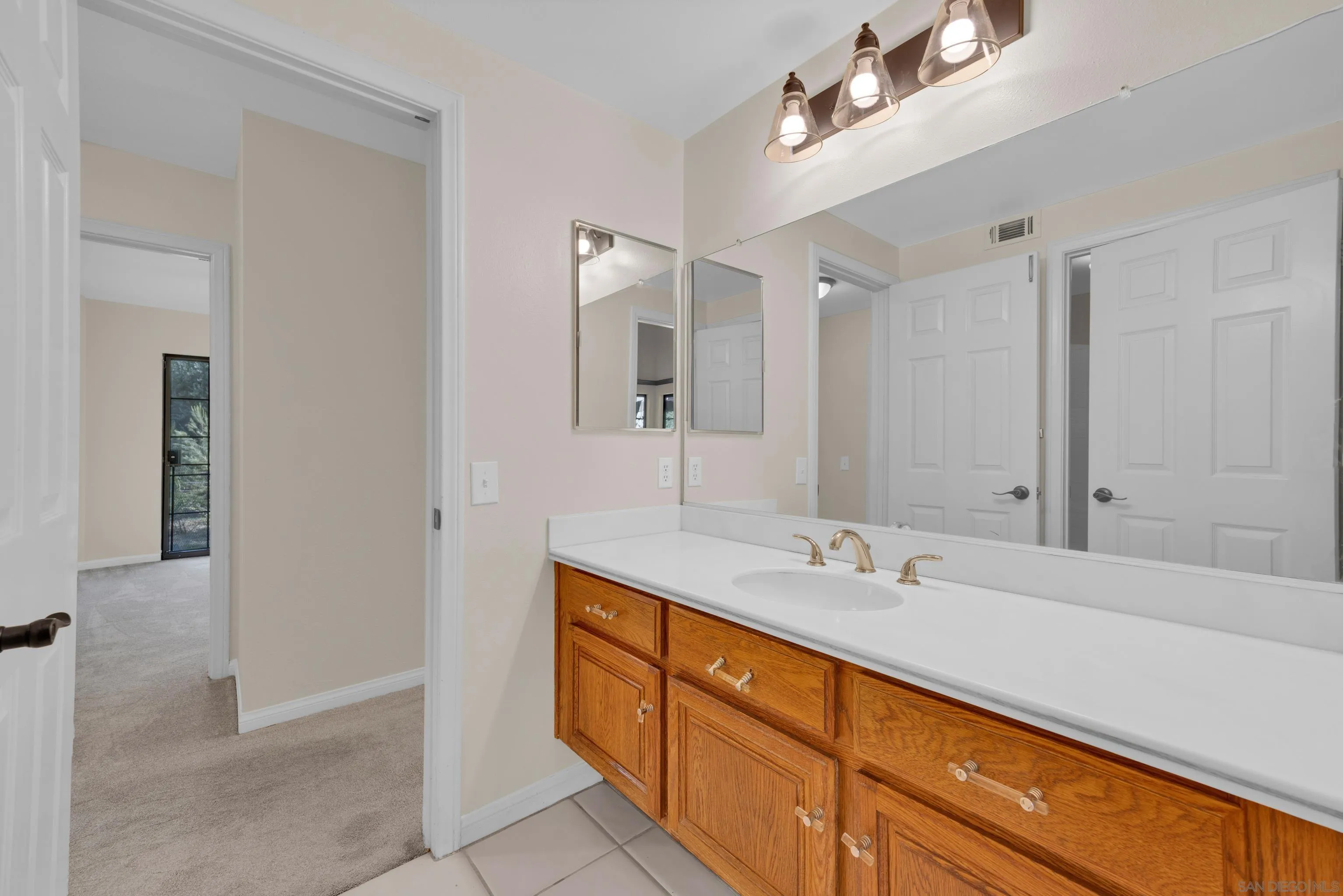 15235 Crestview Court Poway, CA 92064 - Photo 41 of 75 a bathroom with a sink and a mirror