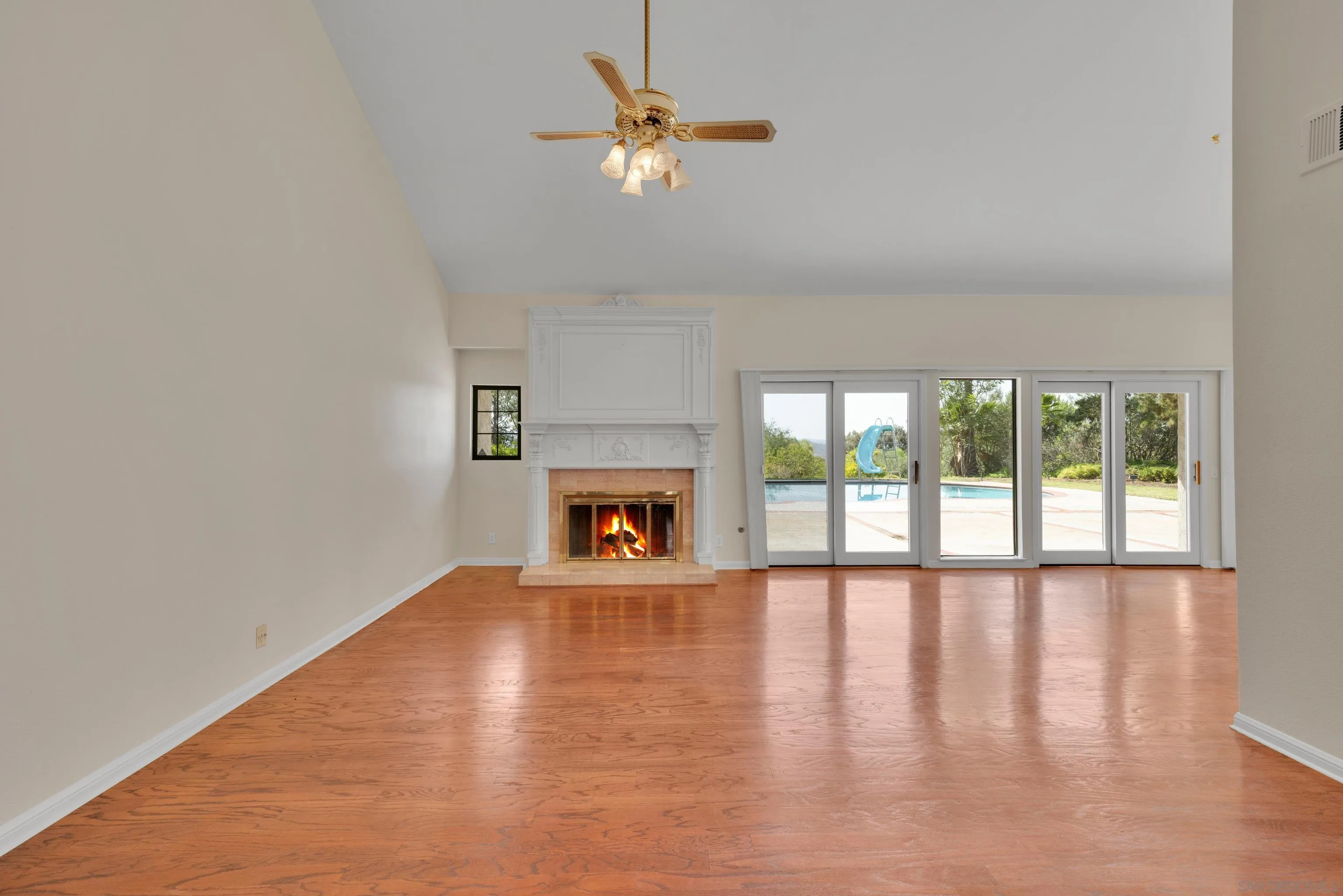 15235 Crestview Court Poway, CA 92064 - Photo 7 of 75 a view of an empty room with a fireplace and a window
