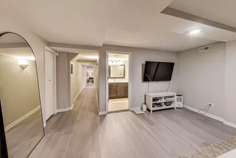 a view of a livingroom with wooden floor and furniture