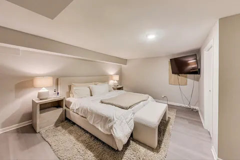 a bedroom with a bed and a flat screen tv