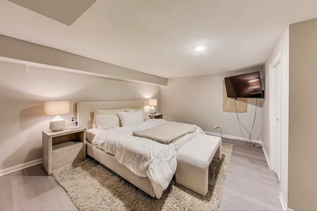 a bedroom with a bed and a flat screen tv