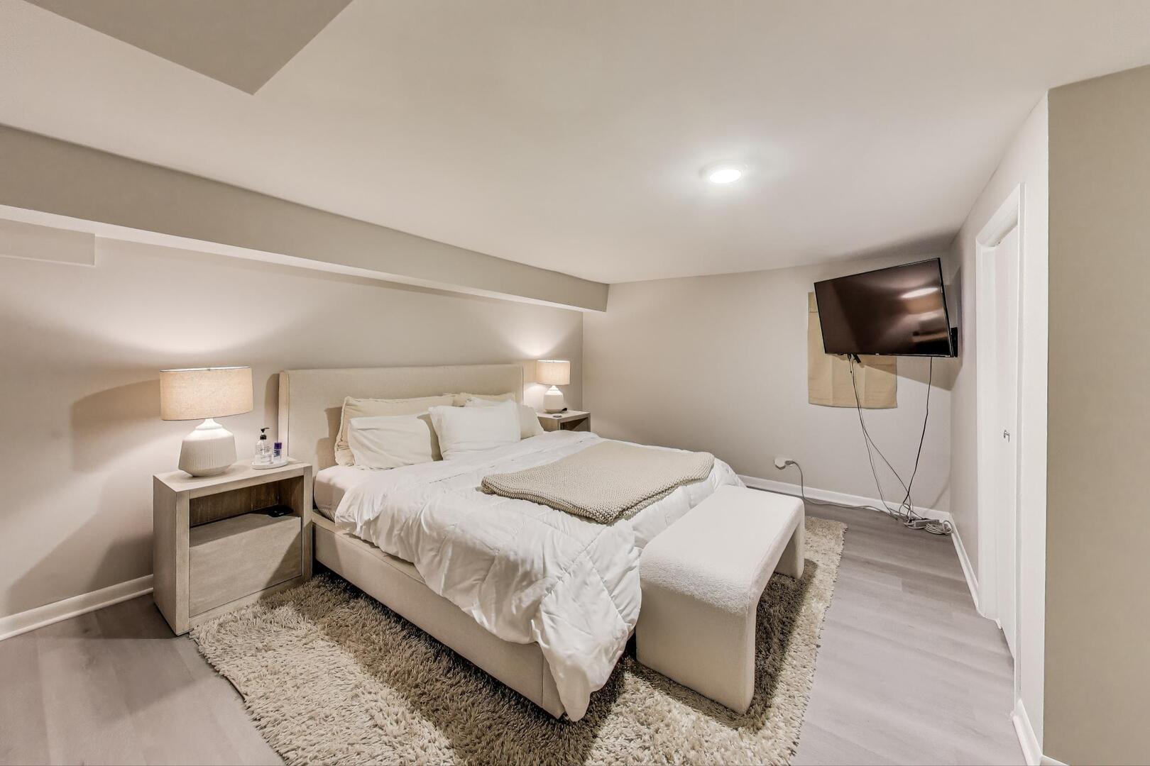 1521 North Paulina Street, Unit 1F Chicago, IL 60622 - Photo 15 of 21 a bedroom with a bed and a flat screen tv