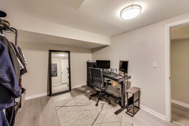 a view of a workspace with furniture and a window
