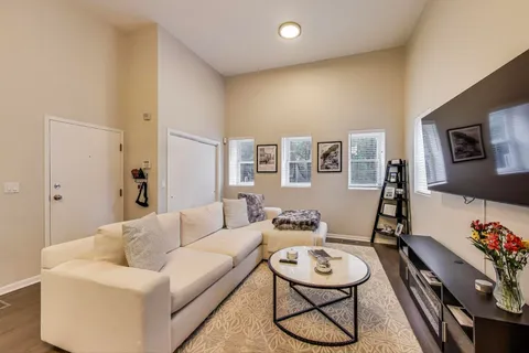 a living room with furniture and wooden floor