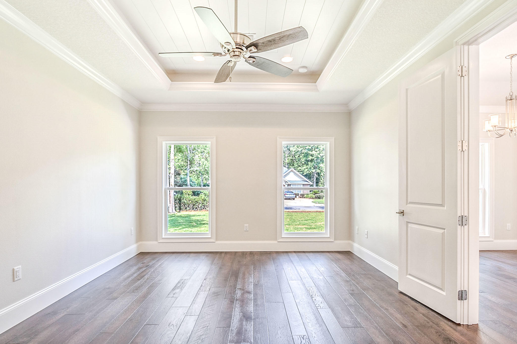 4809 Grove Street Crestview, FL 32539 - Photo 12 of 28 an empty room with wooden floor fan and windows