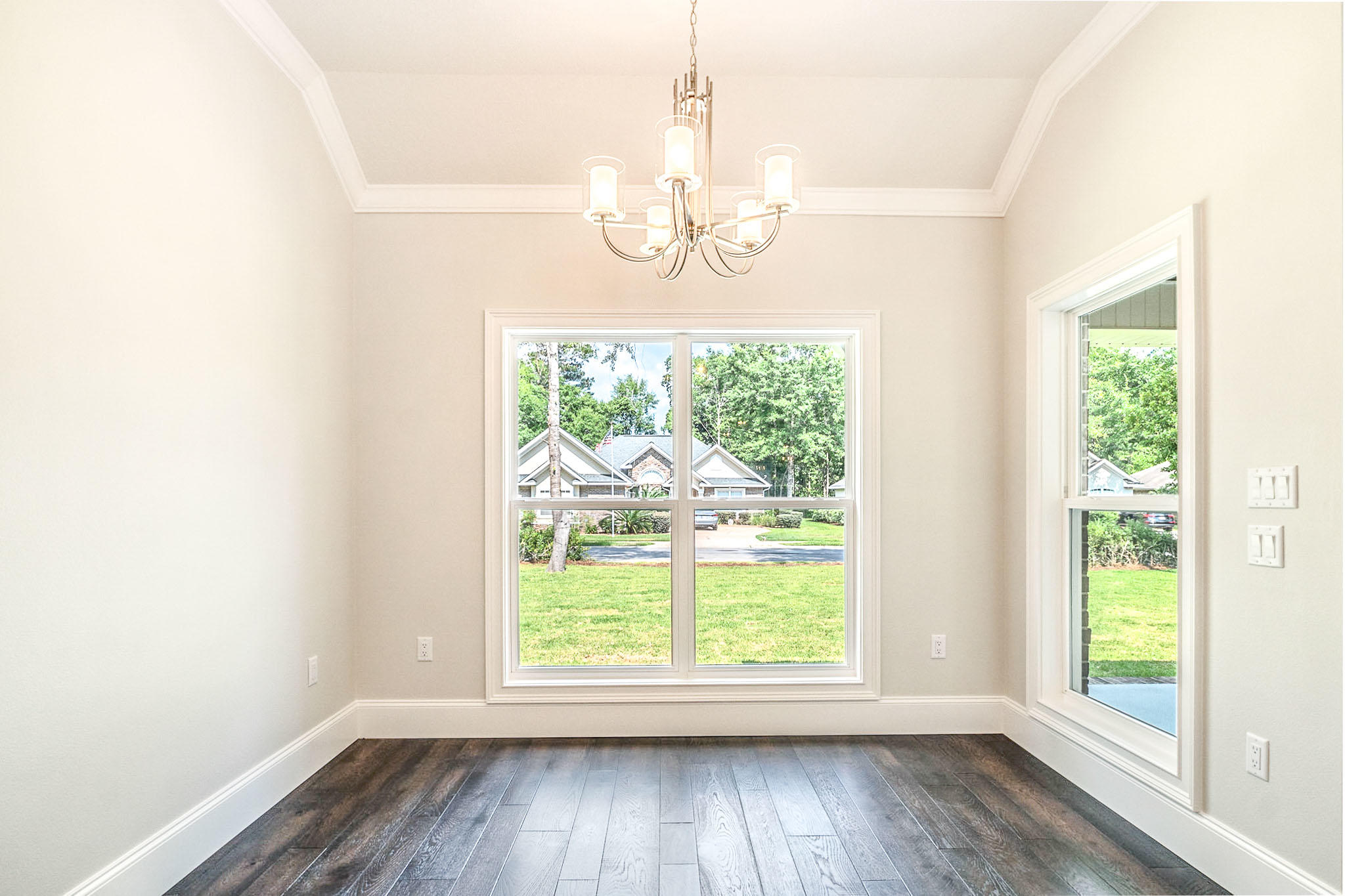 4809 Grove Street Crestview, FL 32539 - Photo 13 of 28 an empty room with wooden floor and windows