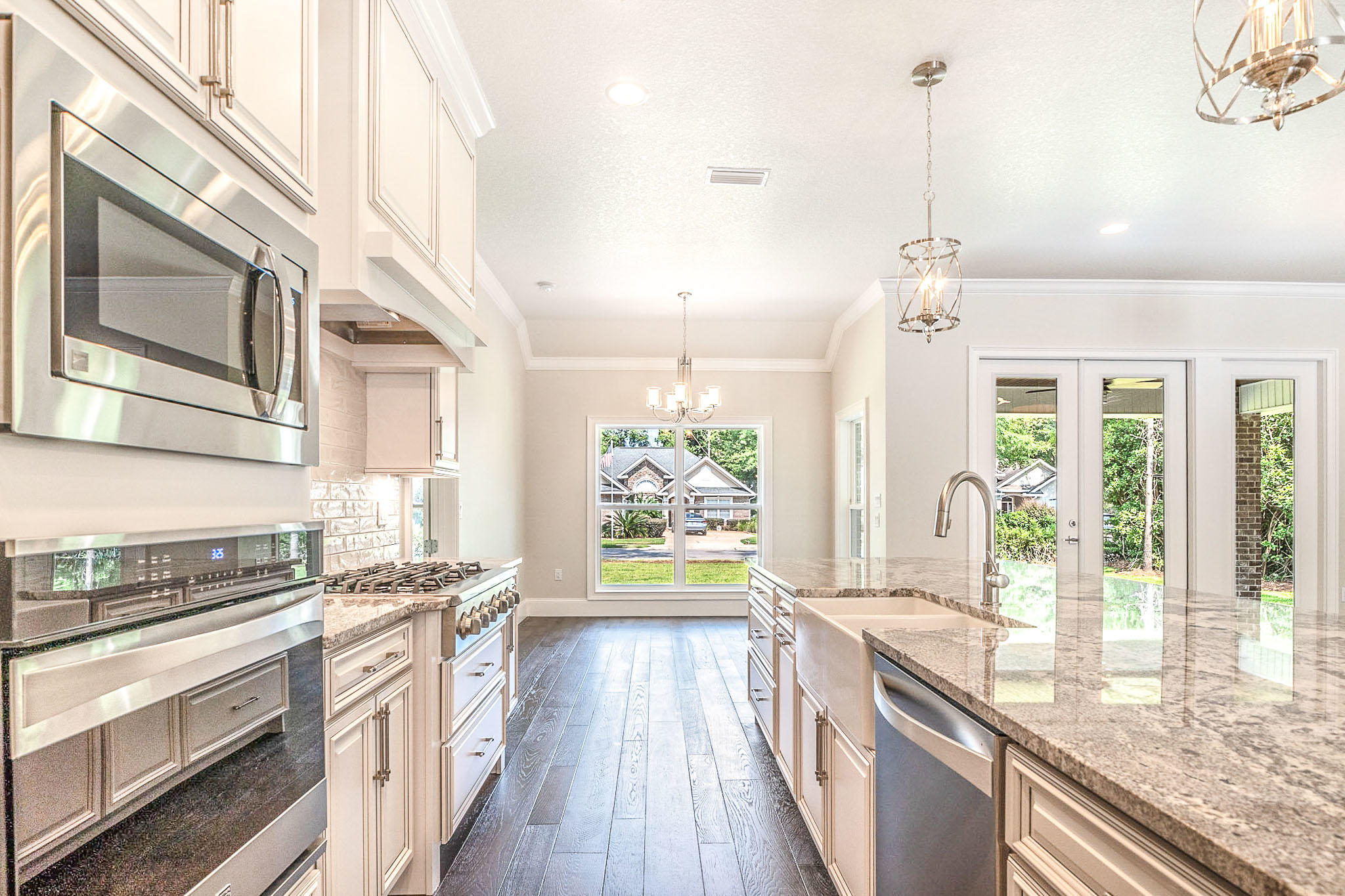 4809 Grove Street Crestview, FL 32539 - Photo 14 of 28 a kitchen with stainless steel appliances granite countertop a stove a sink and a refrigerator
