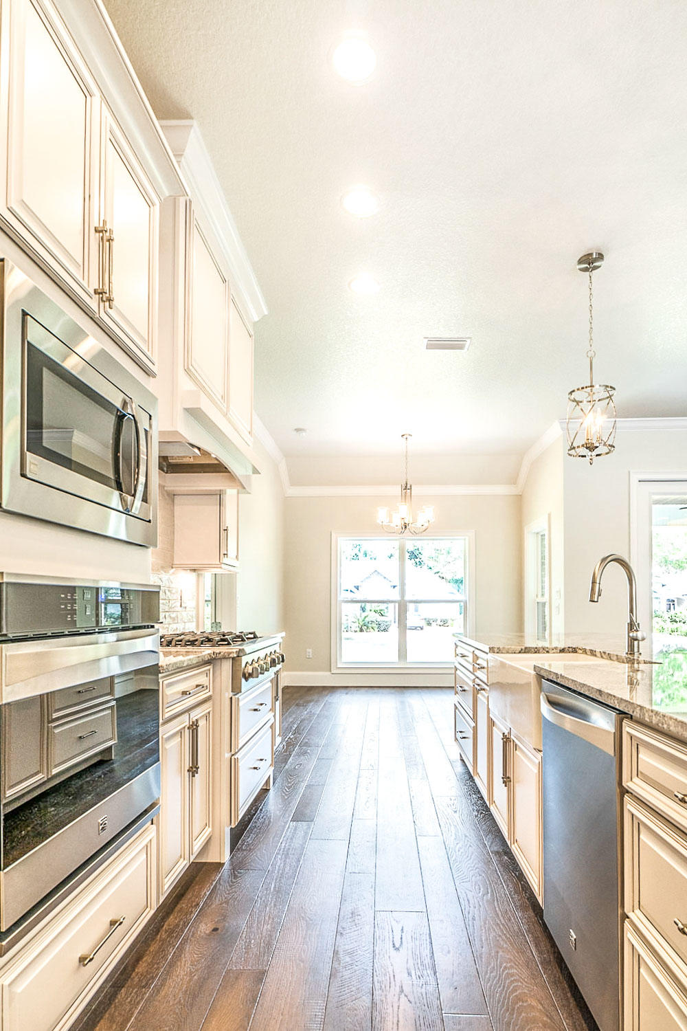 4809 Grove Street Crestview, FL 32539 - Photo 15 of 28 a large kitchen with stainless steel appliances granite countertop a stove and a sink