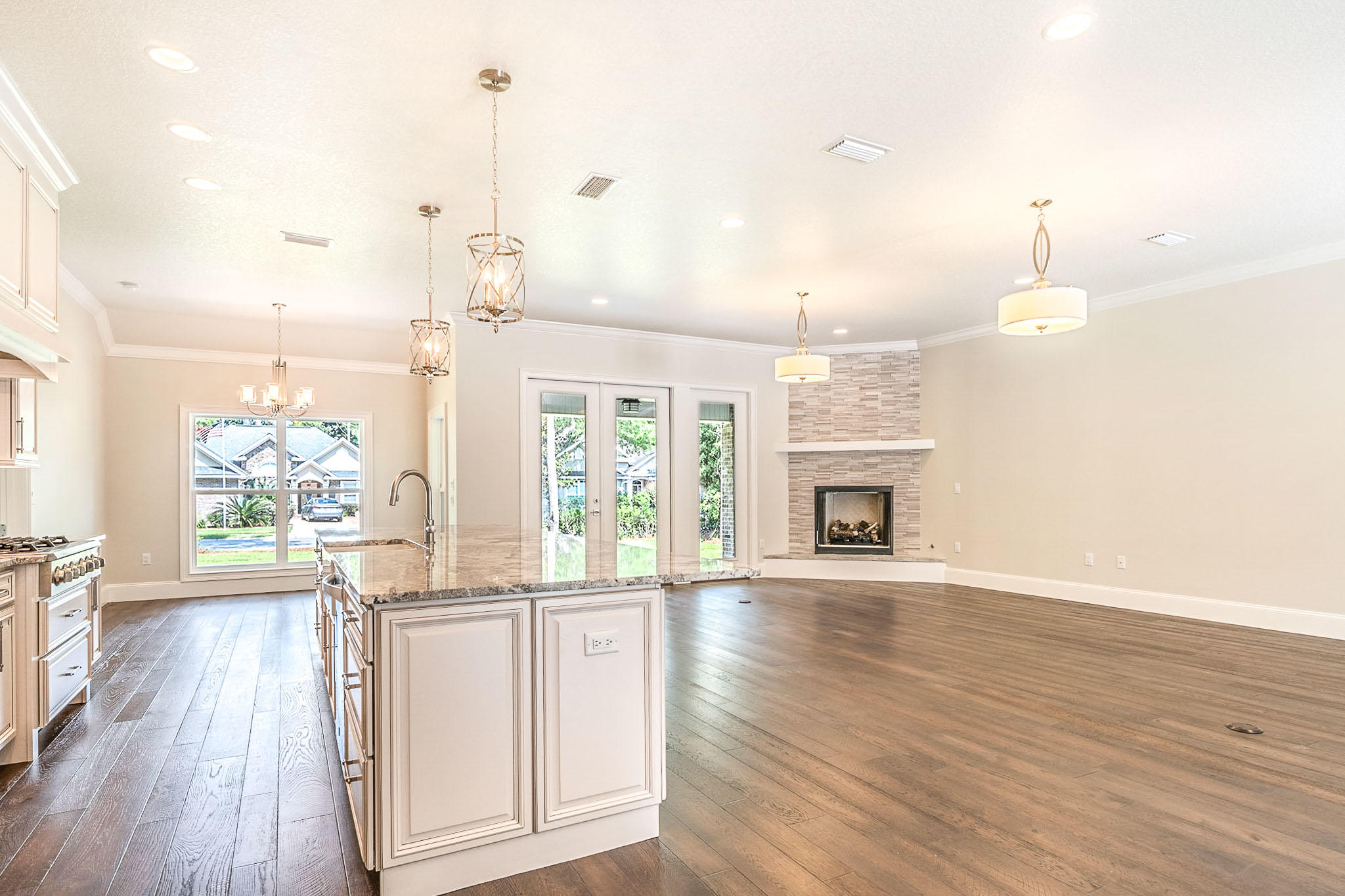 4809 Grove Street Crestview, FL 32539 - Photo 16 of 28 wooden floor in an empty room with a fireplace